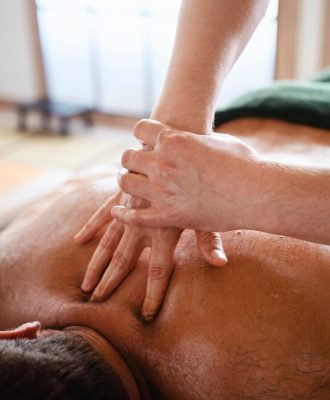 high-angle-man-getting-massage_23-2150649758